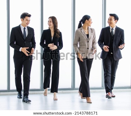 Group of young happy Asian male and female professional successful businessman and businesswoman colleagues partnership teamwork in formal business suit smiling walking side by side forward together. Royalty-Free Stock Photo #2143788171