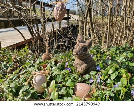 Easter bunny with easter eggs in nature. The Easter Bunny is a folkloric figure and symbol of Easter.
