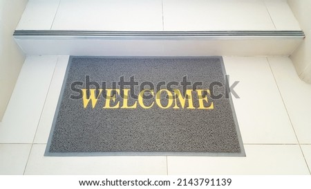 The doormat is made of synthetic material with the word welcome screen printed.
