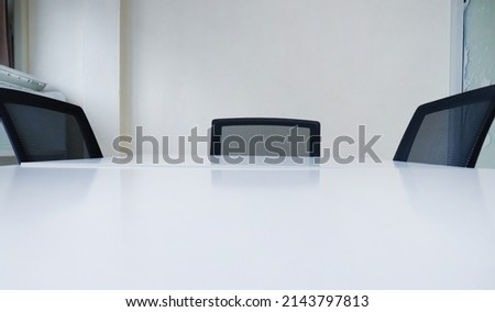 White conference table, 3 chairs in meeting room