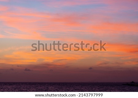 Beautiful view of the sea and the sky in the clouds at sunset. Orange red dawn, dusk on the sea coast. High quality photo