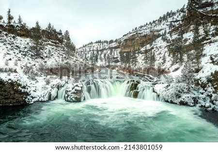 River waterfall among snowy mountains. Cold river waterfall in the snow. Cold river waterfall in the snowy mountains. Cold river waterfall in the snow canyon Royalty-Free Stock Photo #2143801059