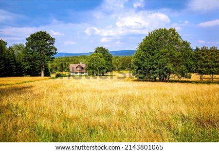 Farm house in the middle of a field. Farm house on farmland in forest field. Landscape of farm land. Agricultural farm field landscape Royalty-Free Stock Photo #2143801065