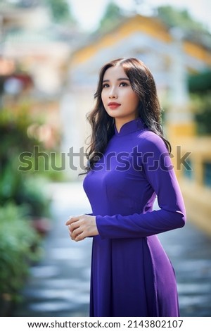 Ho Chi Minh city, Viet Nam: Vietnamese girl going to pagoda in ao dai Royalty-Free Stock Photo #2143802107
