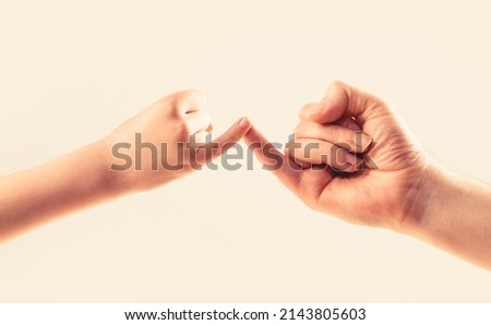 Father, daughter hand making promise friendship concept. Child hook little finger together. Little finger of the two hands hold together. Show friendship and forgiveness. Royalty-Free Stock Photo #2143805603