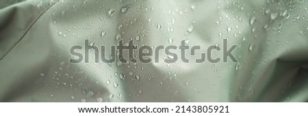 waterproof fabric with waterdrops. non woven fabric water texture background Water drops on waterproof nylon fabric. soft focus Royalty-Free Stock Photo #2143805921