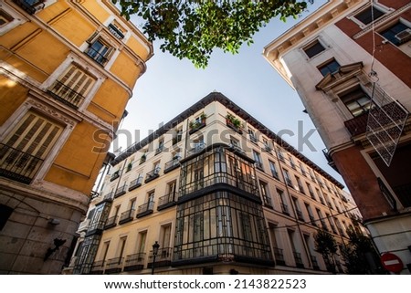 Exterior view of colorful historical buildings in Central Madrid, Spain, Europe. Traditional European street scene in the Chueca neighborhood of the Spanish capital. Royalty-Free Stock Photo #2143822523