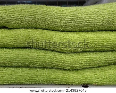 Defocused Close-up stack of green towels