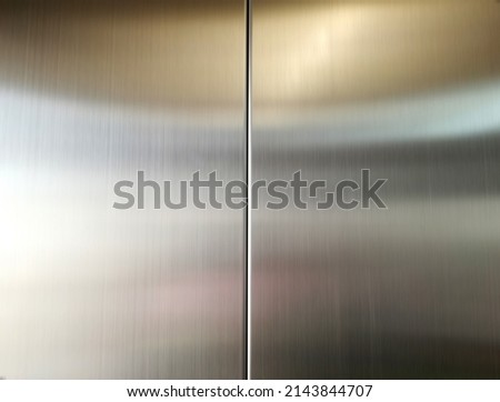 Stainless steel large sheet  With light hitting the surface  For background,Inside passenger elevator,Reflection of light on a shiny metal texture,stainless steel background. Royalty-Free Stock Photo #2143844707