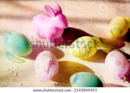 Easter decoration with pink bunny and colorful egg. Easter greeting card. Soft light and pastel colors