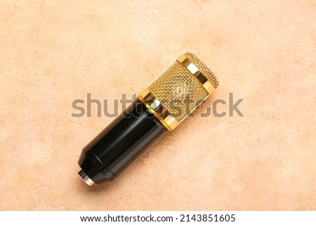 New modern microphone on color background