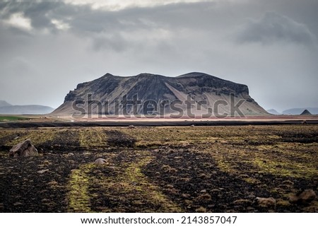 Alone rocky volcanic mountain in desert terrain. Iceland Royalty-Free Stock Photo #2143857047