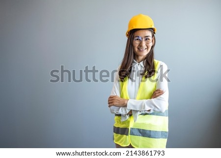 Beautiful asian woman engineer and safety helmet on gray background, construction concept, Engineer, Industry.  Construction girl working concept.