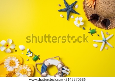 Summer beach design concept. Top view of holiday travel with shells, hat, slipper on yellow background.