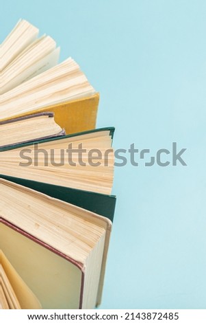 Old vintage books on blue background. World Book Day poster. Education concept