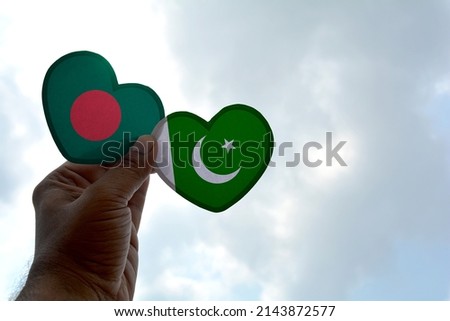 Hand holds a heart Shape Bangladesh and Pakistan flag, love between two countries