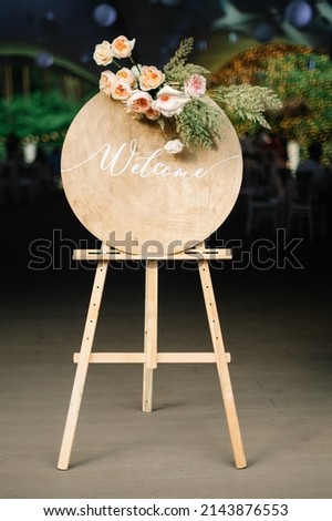 Handmade board with welcome sign on it decorated with eucalyptus. Wedding. Reception.