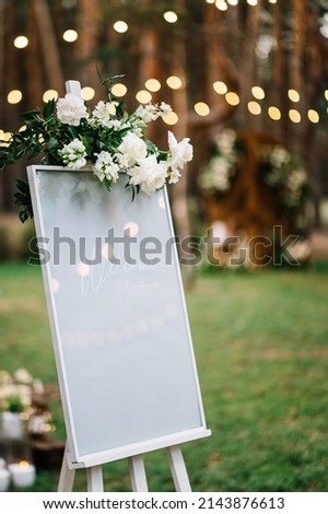 Handmade board with welcome sign on it decorated with eucalyptus. Wedding. Reception.