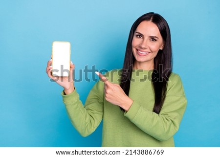 Portrait of positive charming person direct finger empty space display isolated on blue color background