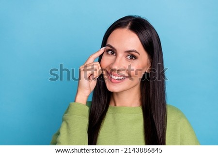 Photo of positive charming young girl touching forehead ask you to remember think isolated on blue color background