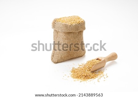 Wheat groats in bowls and bags isolated on a white background. High quality photo Royalty-Free Stock Photo #2143889563