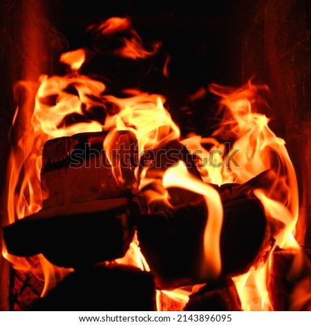 Fire. Photo of flames devouring firewood in a stone fireplace. The texture of the fire in the fireplace.