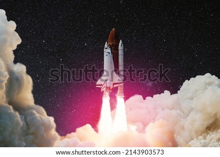 Spaceship lift off. Space shuttle with smoke and blast takes off into the starry sky. Rocket starts into space. Concept. Elements of this image furnished by NASA.