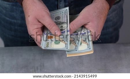 US Dollar. American money. Worldwide money. Man's hand counting dollars