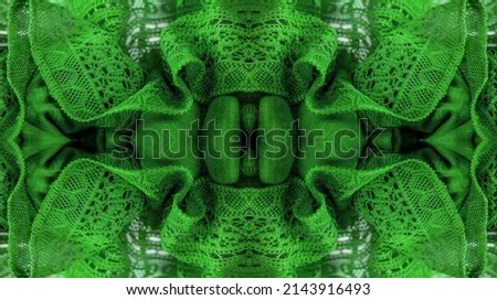 Green lace fabric, thin open fabric, usually cotton or silk. Green wrinkled lace on white spandex background, macro view. Background texture, pattern.