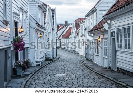 Curvy street with old nice white houses in historical center of Stavanger city, Norway - architecture background