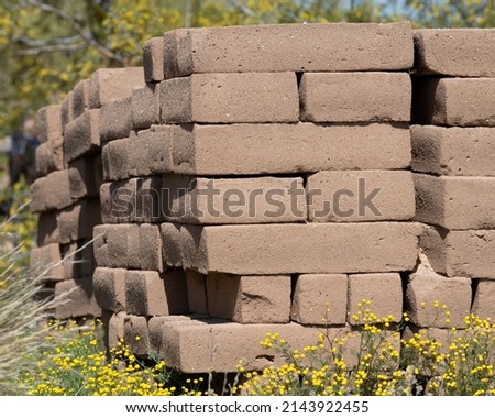 Pile of adobe blocks in a field