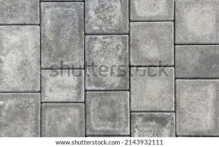 Rough textured surface of large gray paving slabs, close up. Pavement tile pattern, top view