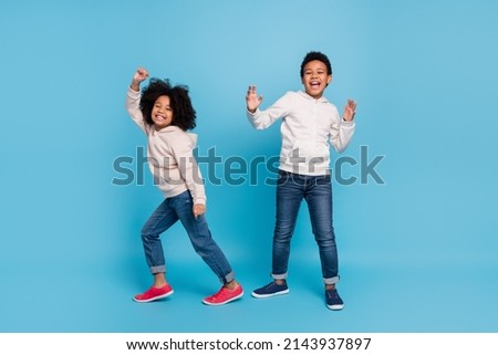 Full length body size view of attractive cheerful kids dancing moving having fun isolated over bright blue color background Royalty-Free Stock Photo #2143937897