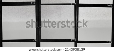 photo of black and white medium format hand copy contact sheet with empty frames and interesting paper surface. retro photo placeholder. Royalty-Free Stock Photo #2143938139