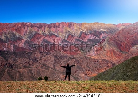 Selective Focus. The Hornocal, Jujuy Argentina. Hill of fourteen colors. Happy person in El Hornocal. person posing from behind in El Hornocal. Beautiful landscape of Argentina Royalty-Free Stock Photo #2143943181