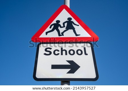 Upwards angle looking at a school crossing sign