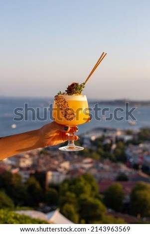 girl holding cocktail against view. girl is drinking delicious cocktail. Summer cocktail. peach, cherry, strawberry, orange. Delicious punch. Fruits and cocktails. punch.