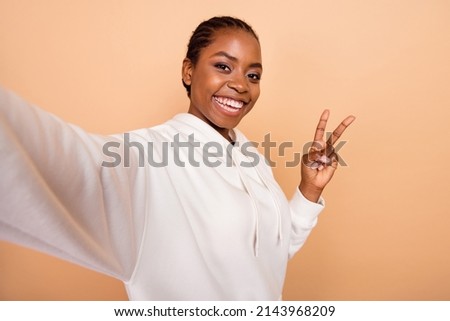 Photo of positive charming person take selfie fingers make v-sign isolated on beige color background