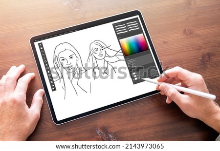 Person drawing sketches on digital tablet Royalty-Free Stock Photo #2143973065
