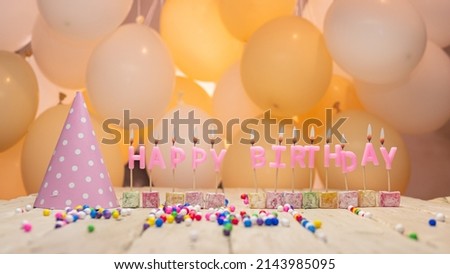 Beautiful happy birthday background with burning candles for any age, birthday candles pink letters. Festive background with balloons