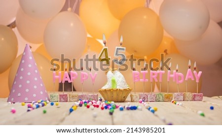 Beautiful background happy birthday number 45 with burning candles, birthday candles pink letters for forty five years. Festive background with balloons