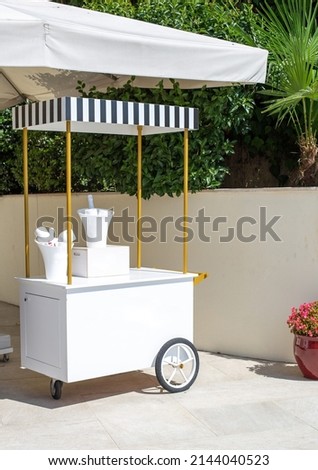 white champagne trolley. ice cream cart for mockup. Summer cart, summer trolley. Luxury cart. Royalty-Free Stock Photo #2144040523