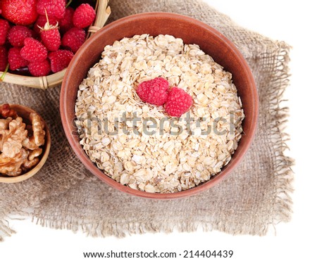Wooden bowls of berries on sackcloth isolated on white