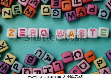 Zero waste word on colorful plastic block cube. Selective focus. Colorful dice on turquoise background. 