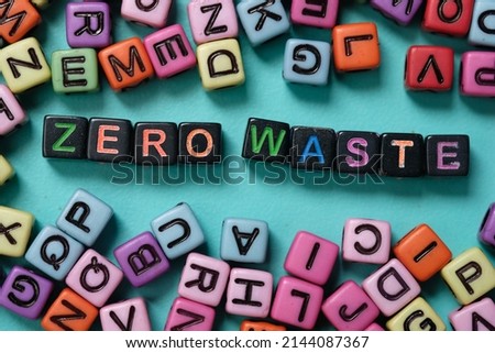 Zero waste word on colorful plastic block cube. Selective focus. Colorful dice on turquoise background. 