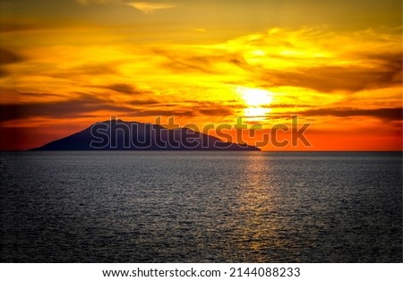 Silhouette of the island at sunset. Sundown sea landscape. Sundown sea at sunset. Beautiful sunset sky over cloudy sky Royalty-Free Stock Photo #2144088233