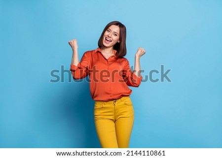 Photo of young cheerful excited girl rejoice success fist hands awesome isolated over blue color background Royalty-Free Stock Photo #2144110861