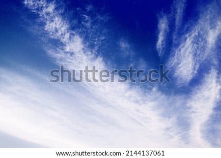 White сirrus clouds on dark blue sky background closeup, cirrostratus cloud, spindrift clouds, fluffy wispy cloudy skies texture, beautiful cloudscape view, sunny heaven, cloudiness weather backdrop Royalty-Free Stock Photo #2144137061