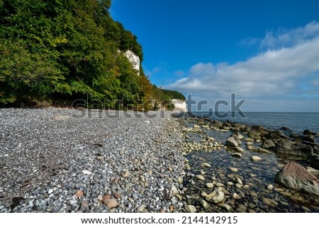Natural stone beach in the pirate bay in the Jasmund National Park near Sassnitz. On the one hand the Kredefelsen of the island of Rügen and on the other hand the Baltic Sea.