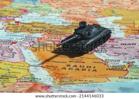 Toy tanks on the map. Armed conflict in the Middle East. Royalty-Free Stock Photo #2144146033